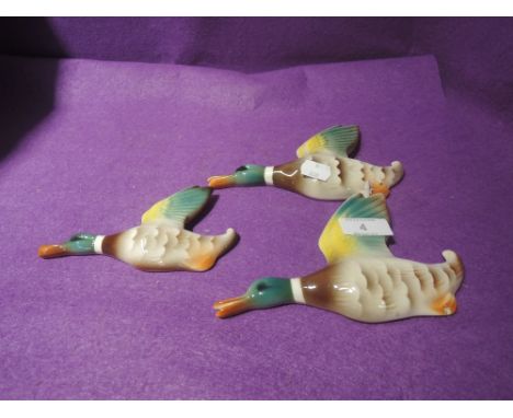 A set of ceramic wall mounted graduated ducks