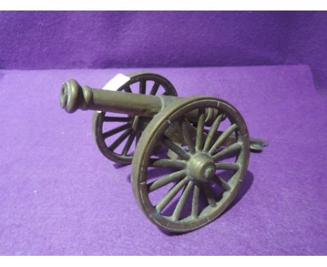 A brass model replica of a cannon
