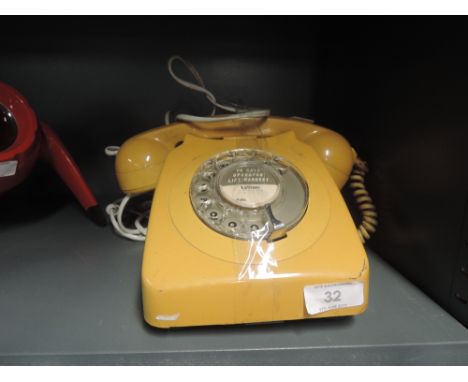 A vintage telephone by GPO with mustard colour body