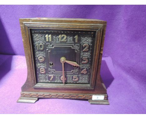 A bracket clock or similar with chime and Art Deco design face plate