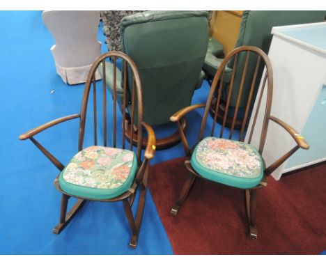 A pair of dark stain Ercol rockers