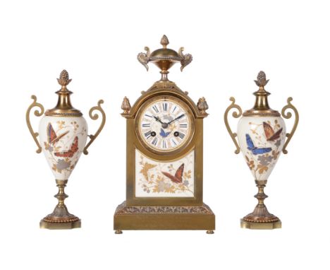 
	
		A French gilt brass and porcelain mantel clock garniture with unusual glass bead highlighted decoration
		Achille Brocot