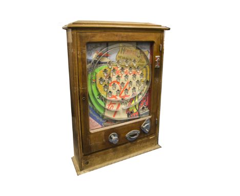 A Wanders Allwin 'Honest Joe Nevanok' penny flick slot machine, with spiral leading to 24 winning holes, glass front with oak