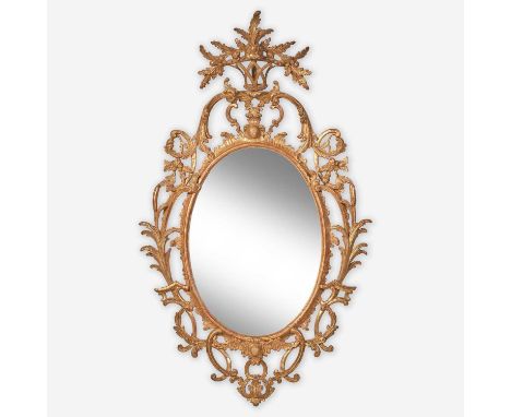 A rare Chippendale oval carved and gilded pine looking glass, Probably English, circa 1760-1780The frame intricately carved w