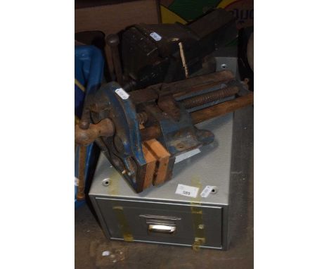 Two bench vices and a metal filing cabinet