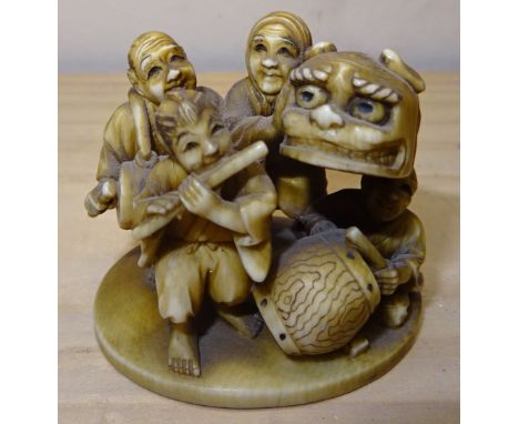 A 19th Century Japanese ivory Netsuke finely carved with figures of four musicians and with signature mark to base. 