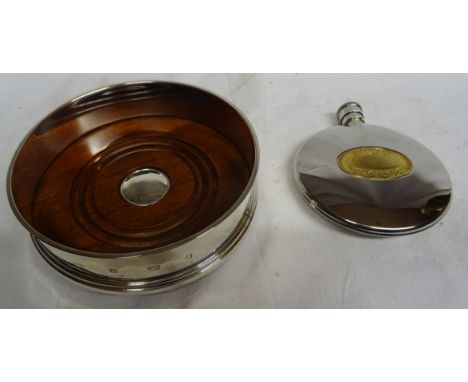 A modern silver circular Coaster with wooden base and a Dalvey plated Hip Flask.