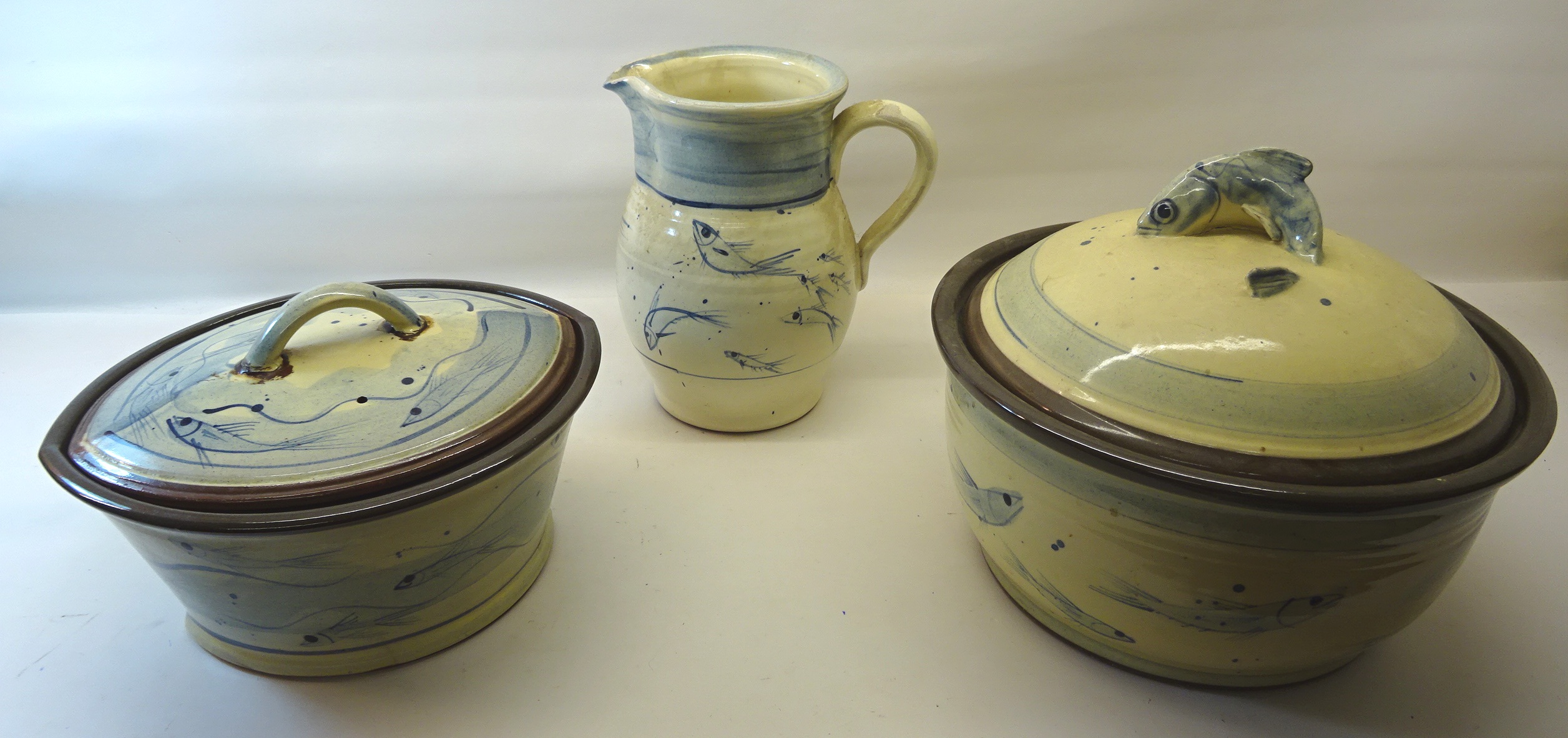 A Whitby Harbour Side Pottery Jug, decorated with fish. 8 1/2" (22cms) high a similar oval servi