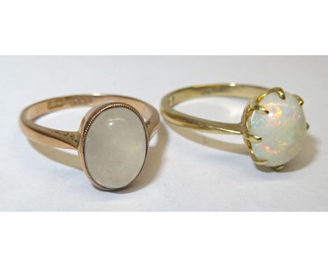 A 9ct. gold Dress Ring set with an oval cabochon opal and another 9ct. gold ring with a cabochon moonstone. 