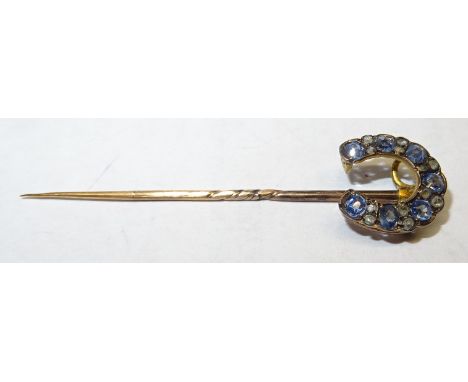 A horseshoe shape Stick Pin set with sapphires and diamonds.