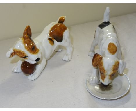 A Royal Doulton Puppy eating from a plate and another playing with a ball.