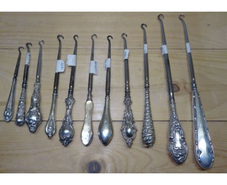 A collection of eleven silver handled Button Hooks, various sizes. 
