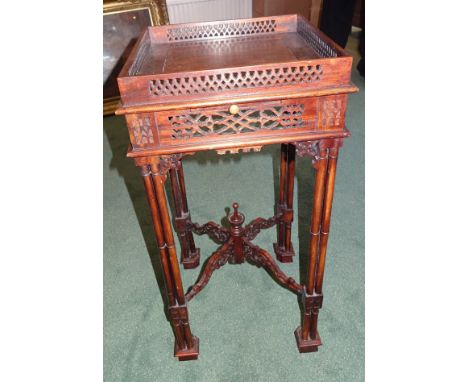 A reproduction mahogany Lamp Table with pierced gallery and candle slide, on turned cluster columns.  13" (33cms) wide. 