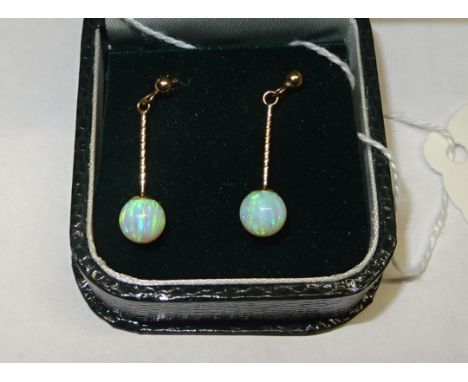 A pair of 9ct. gold pendant Earrings each set with a single opal. 