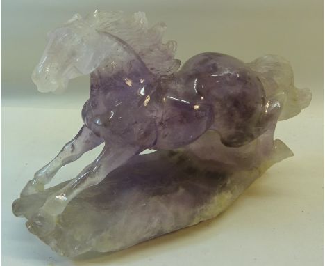 A carved amethyst Model of a Running Horse, 6" (15cms) long.