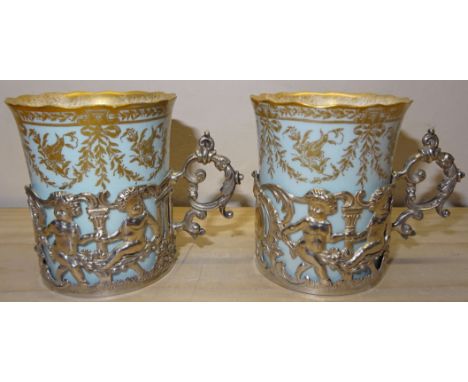 A pair of Worcester Coffee Cans with gilt decoration in pierced silver holders, Sheffield 1906 by Mappin & Webb. 