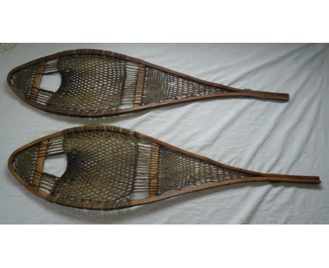 A pair of vintage wooden Snow Shoes with woven panels.  32" (82cms) long. 