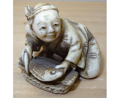 Another 19th Century Japanese Netsuke carved as a woman cleaning a fish and with signature mark to base. 