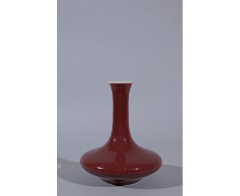 Oxblood-glazed Cabinet Vase, China.  Compressed bottle-form with a long straight neck, six-character mark on base in undergla