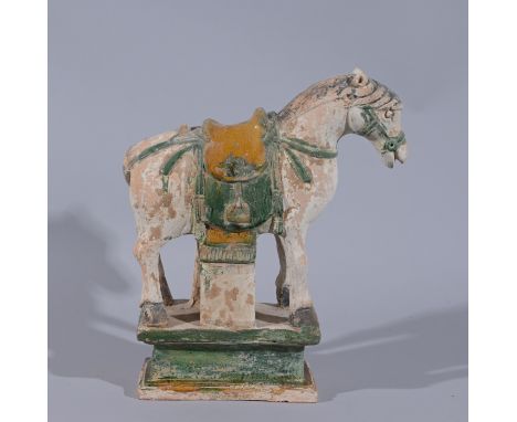 Ming Dynasty Glazed Terracotta Horse Statue.  A Sancai terracotta statue of a standing horse, decorated with a saddle, saddle