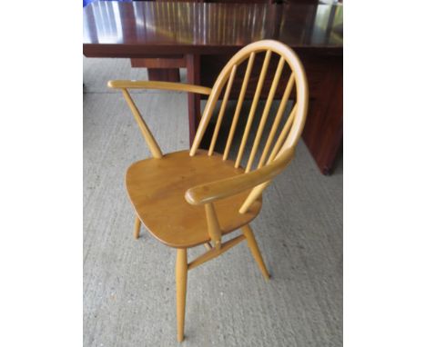 An Ercol light elm elbow chair 