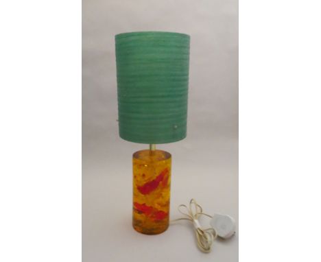 An orange shatterline table lamp base with spun fibre shade