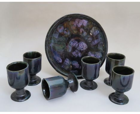 A 1960's Eric Leaper tray with six goblets, mottled green and purple glazes, one restored 