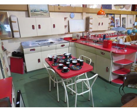 An extensive English Rose kitchen in red and ivory colours, fully restored by Source. The kitchen includes rare cooker and fr