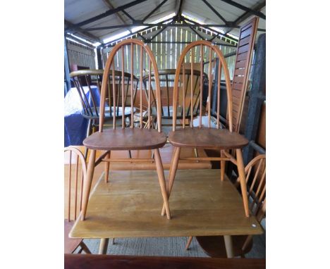 A set of four Ercol dining chairs 