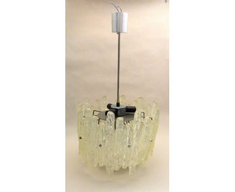 A circular ceiling light formed from textured lucite panels 