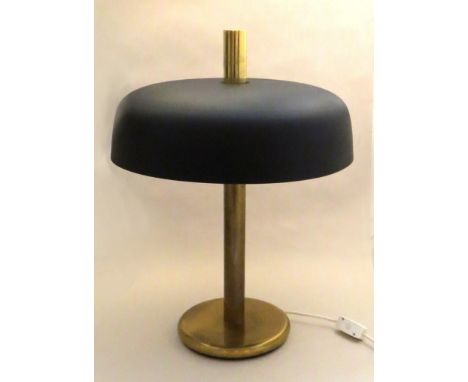 A brassed metal table lamp with matte black shade 