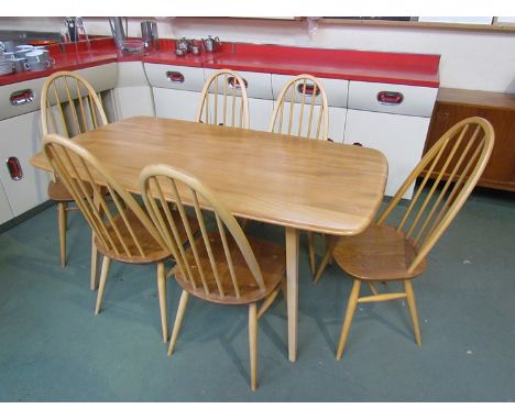 An Ercol light elm dining table with six hoop & stick back chairs. 151cm x 84cm x 72cm