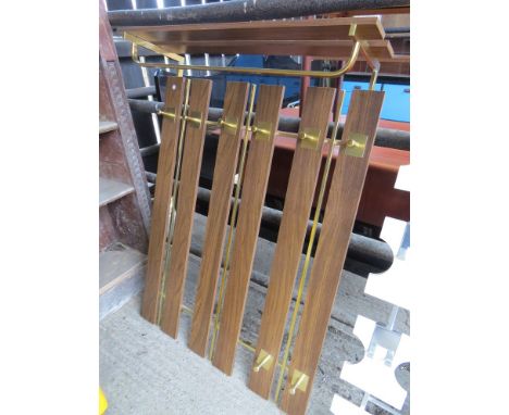 A metal and wood wall hanging coat rack 