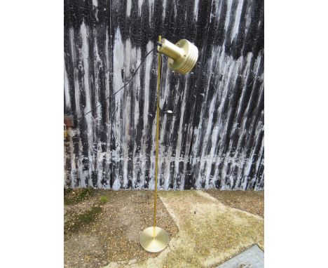 A brassed single spot adjustable standard lamp 