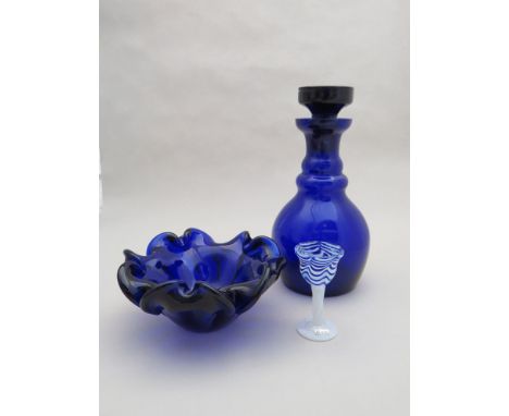 A blue glass decanter, waved art glass bowl in similar colour and a Kosta Boda blue and white liquer glass (3) 