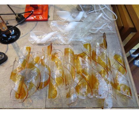 A collection of spiral form glass chandelier sections.