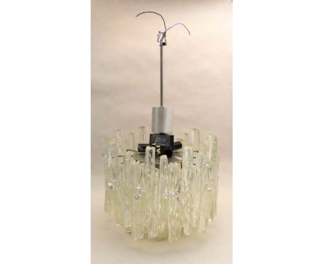 A circular ceiling light formed from textured lucite panels 