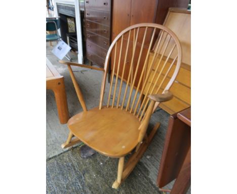 A light wood Ercol rocking chair, solid seat