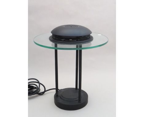 A circular glass and black metal desk lamp by Robert Sonneman for George Kovacs 
