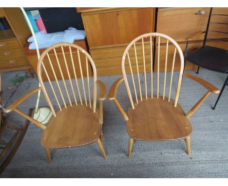 A pair of solid seat Ercol lounge chairs 