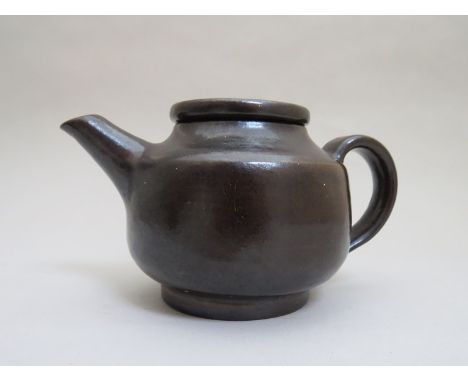 LUCIE RIE (1902-1995) A small studio pottery teapot and lid with a brown treacle glaze. Seal to base 8.5cm high - small chip 