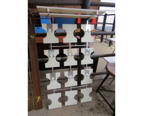 A metal and white painted wall hanging coat rack 