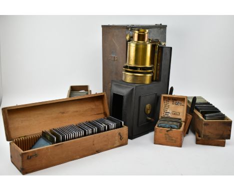 A Victorian mid 19th century cased magic lantern with five wooden boxes of slides. The lantern unmarked, complete in original