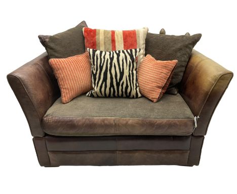 Knole design two-seat snuggler sofa, upholstered in brown leather with scatter cushions upholstered in contrasting striped an