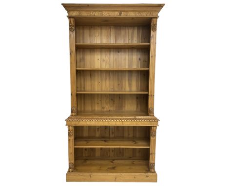 Polished pine and elm bookcase, projecting moulded cornice over three shelves and fluted uprights, leaf and S-scroll carved b