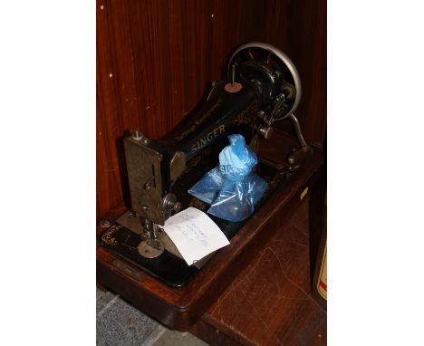 A CASED VINTAGE SEWING MACHINE 