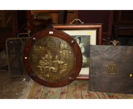 AN OAK FRAMED CIRCULAR BRASS PLAQUE TOGETHER WITH A FIRE SCREEN AND TWO FIRE GUARDS