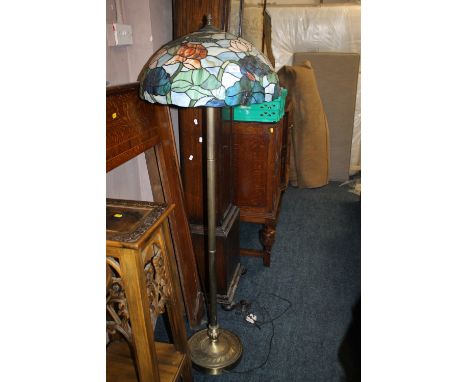 A BRASS LAMP STANDARD WITH LARGE TIFFANY STYLE SHADE