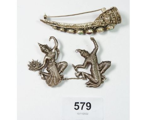 A Siam silver cloak pin in the form of a pair of dancers and a silver and stone set nail guard brooch 