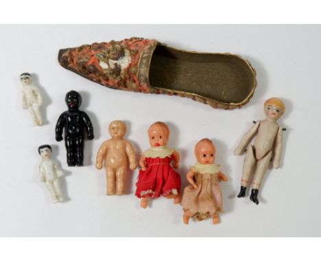 An oriental miniature slipper, a bisque dolls house doll, 5.5cm and various other miniature dolls 